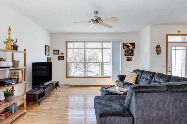 living area with visible vents, plenty of natural light, light wood-style floors, and a ceiling fan