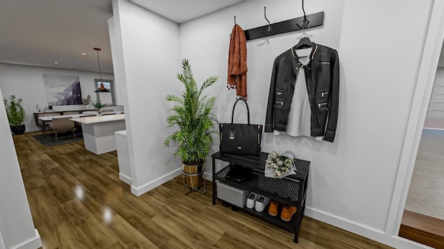 hall featuring wood finished floors and baseboards