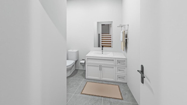 bathroom featuring tile patterned flooring, vanity, and toilet