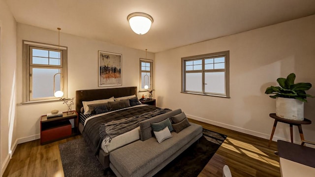 bedroom featuring wood finished floors and baseboards