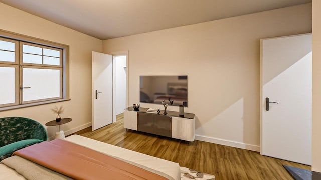 bedroom with baseboards and wood finished floors