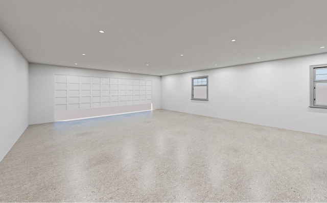 spare room with recessed lighting and speckled floor