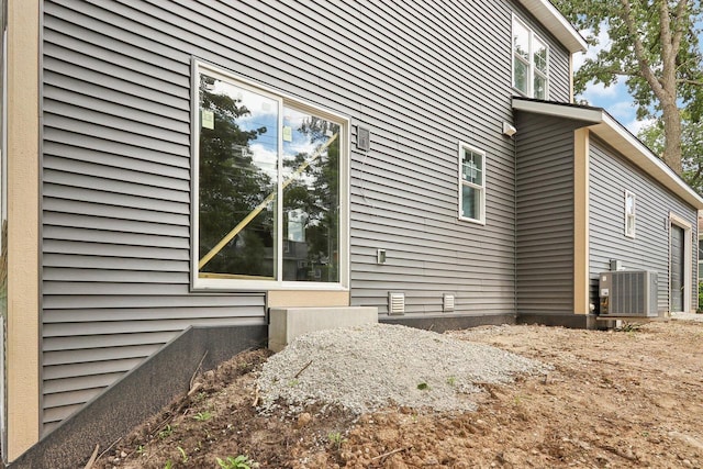 view of side of home featuring crawl space and central air condition unit