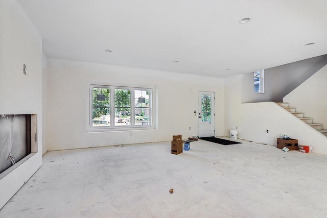 living room with stairs and a wealth of natural light