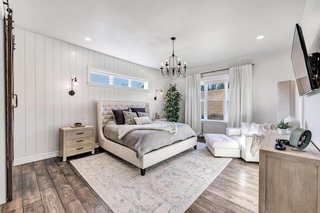 bedroom with baseboards, recessed lighting, dark wood finished floors, and a notable chandelier