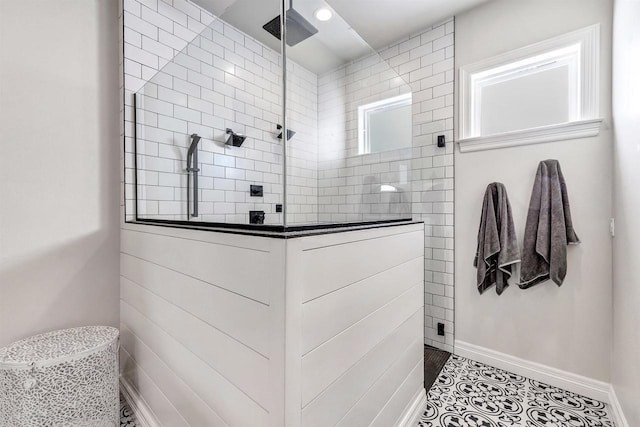 full bathroom featuring tile patterned flooring, visible vents, baseboards, and walk in shower