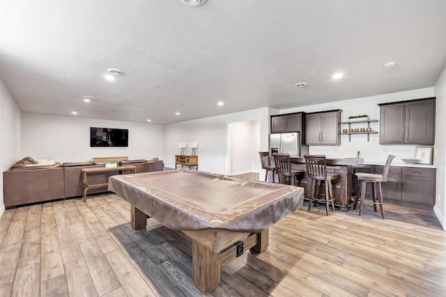 playroom with indoor wet bar, recessed lighting, pool table, and light wood-style flooring