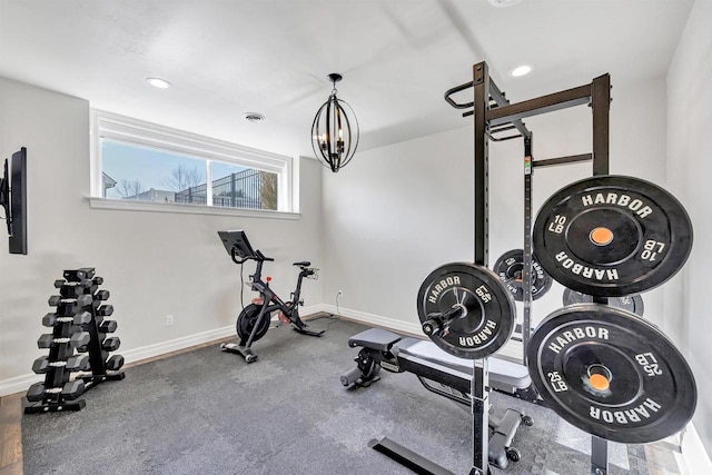 exercise area with visible vents, baseboards, a notable chandelier, and recessed lighting