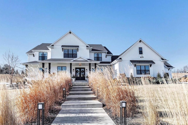 modern farmhouse with covered porch and french doors