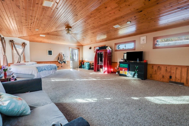 carpeted bedroom featuring lofted ceiling, a wainscoted wall, wood ceiling, and wood walls