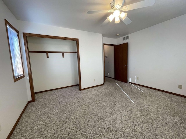 unfurnished bedroom with carpet, a closet, visible vents, and baseboards