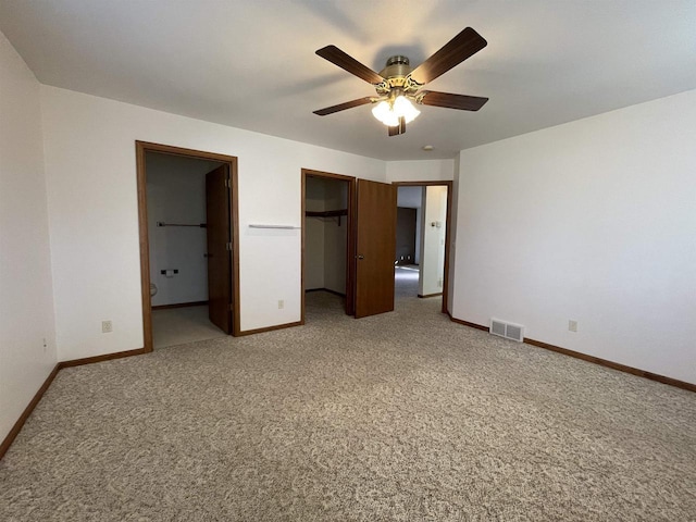 unfurnished bedroom with baseboards, visible vents, and light colored carpet