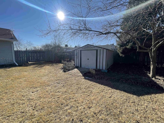 view of yard with an outbuilding, a shed, and a fenced backyard