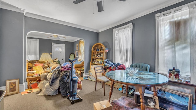 dining area with carpet, arched walkways, and ceiling fan