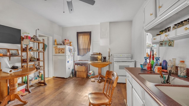 kitchen featuring light wood-type flooring, white appliances, white cabinetry, and ceiling fan