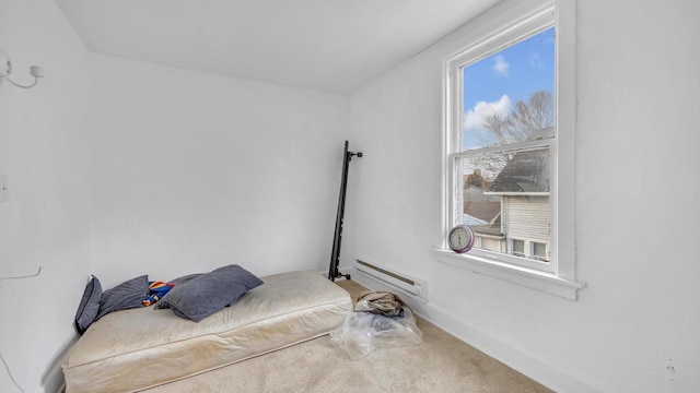 carpeted bedroom featuring multiple windows, baseboards, and baseboard heating