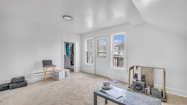 interior space featuring carpet floors, a baseboard radiator, and lofted ceiling