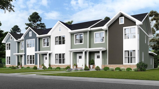 view of property featuring a front yard and brick siding