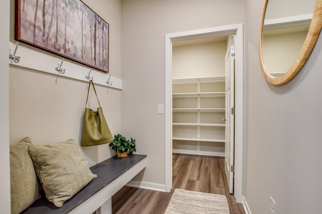 mudroom with baseboards and dark wood-type flooring