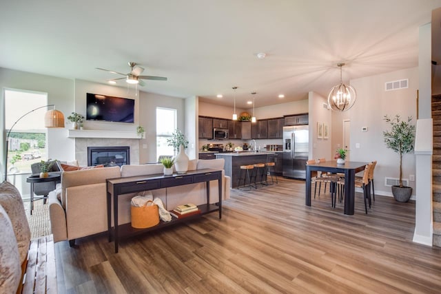 living room with a healthy amount of sunlight, light wood-style floors, and visible vents