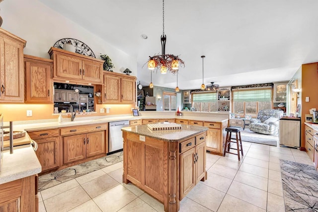 kitchen featuring a peninsula, light tile patterned floors, a sink, and stainless steel dishwasher