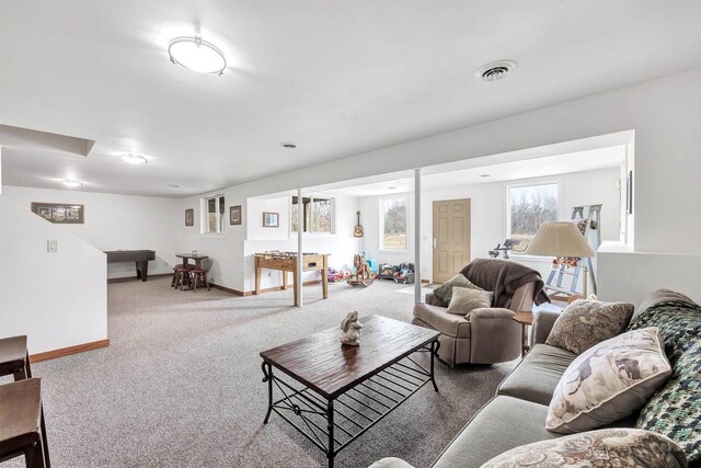 carpeted living area featuring visible vents and baseboards