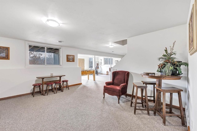 living area featuring carpet and baseboards