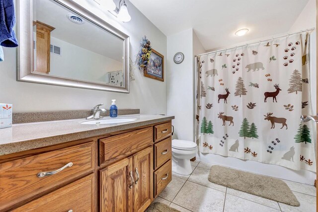 bathroom with shower / bath combo, visible vents, toilet, tile patterned flooring, and vanity