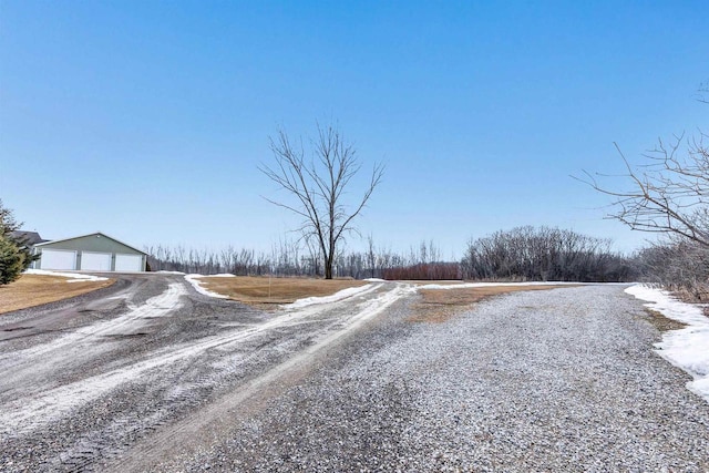 view of street with gravel driveway