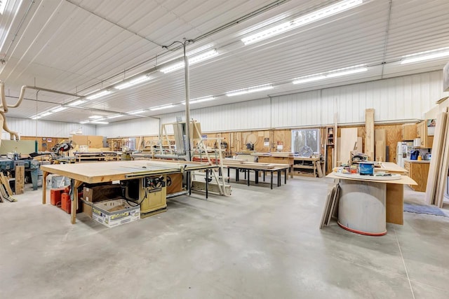 garage featuring metal wall and a workshop area