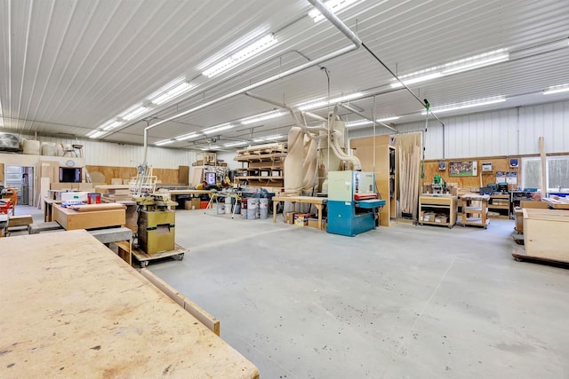 garage featuring a workshop area and metal wall