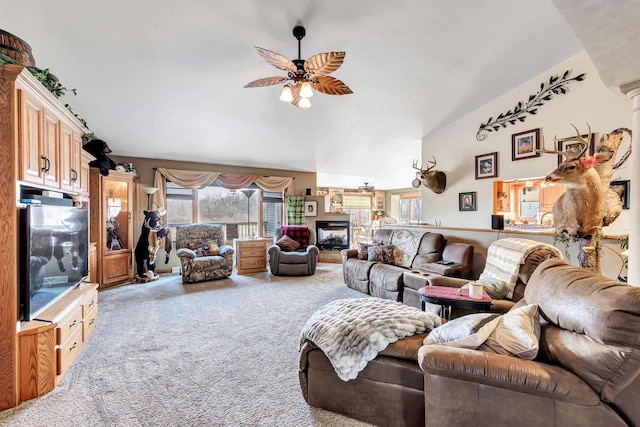 living area with a ceiling fan, carpet flooring, and a multi sided fireplace