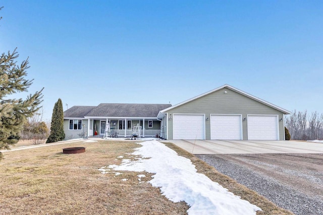 ranch-style home with a porch, a front lawn, driveway, and an attached garage