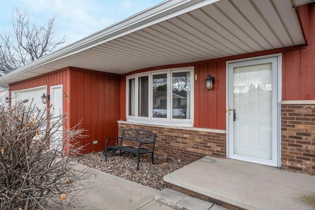 doorway to property featuring brick siding