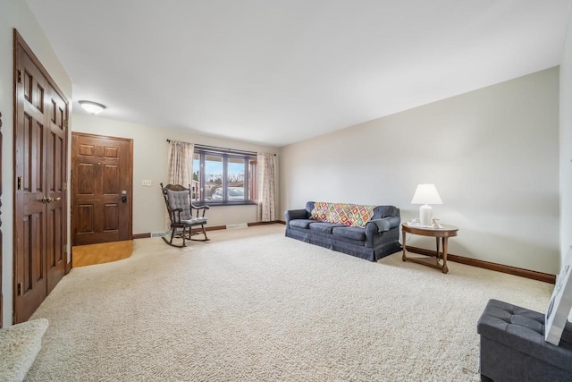 living area with carpet, visible vents, and baseboards