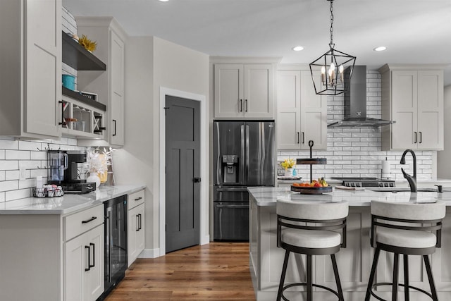 kitchen with beverage cooler, dark wood-style floors, stainless steel refrigerator with ice dispenser, wall chimney range hood, and open shelves