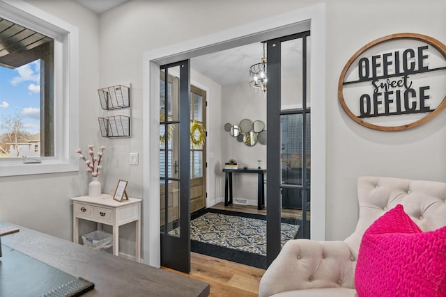 interior space with an inviting chandelier and wood finished floors