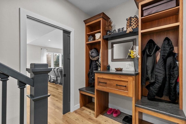 mudroom with light wood-style flooring and baseboards