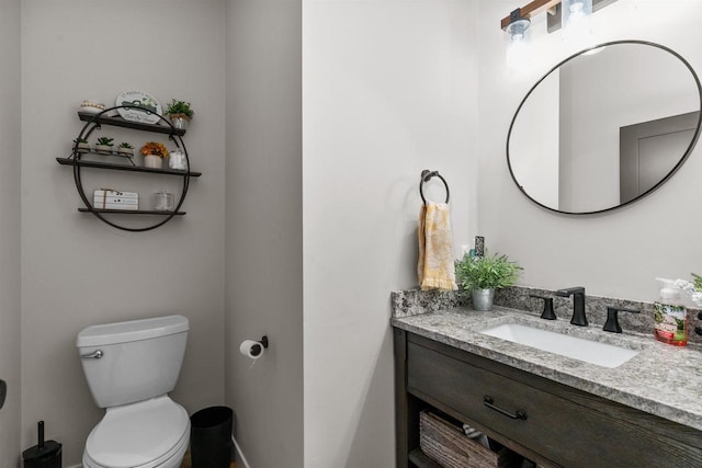 bathroom featuring toilet and vanity