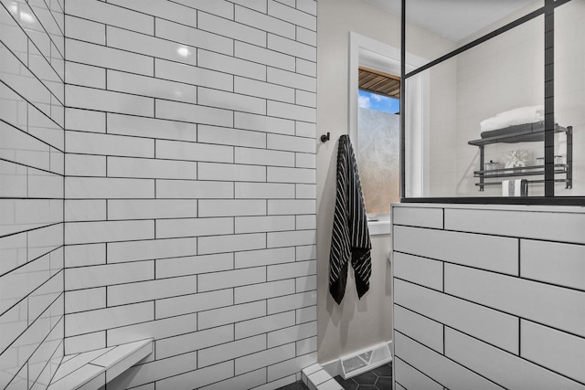 bathroom with a walk in shower and tile patterned flooring