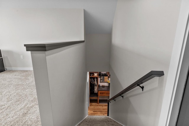 stairway with carpet floors and baseboards