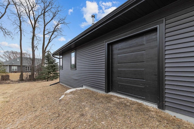 doorway to property with a garage and driveway