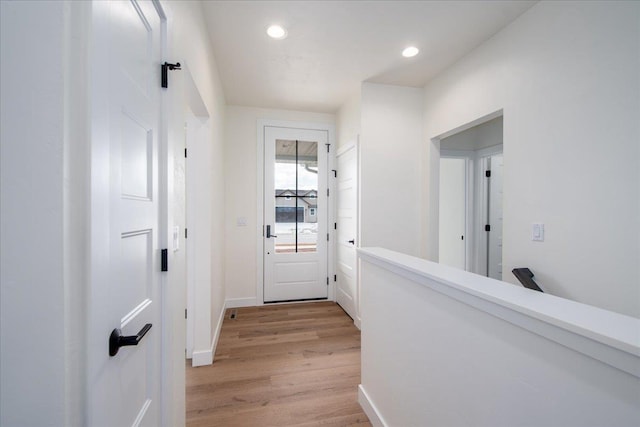 interior space featuring baseboards, recessed lighting, and light wood-style floors