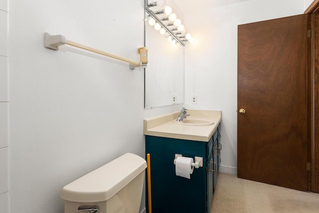 half bath featuring vanity and toilet