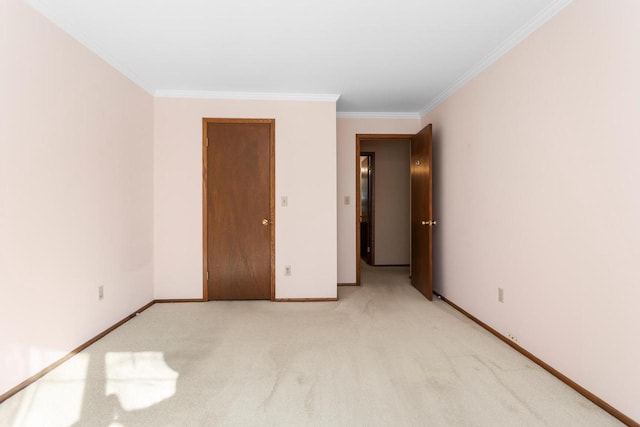 unfurnished bedroom with light carpet, crown molding, and baseboards