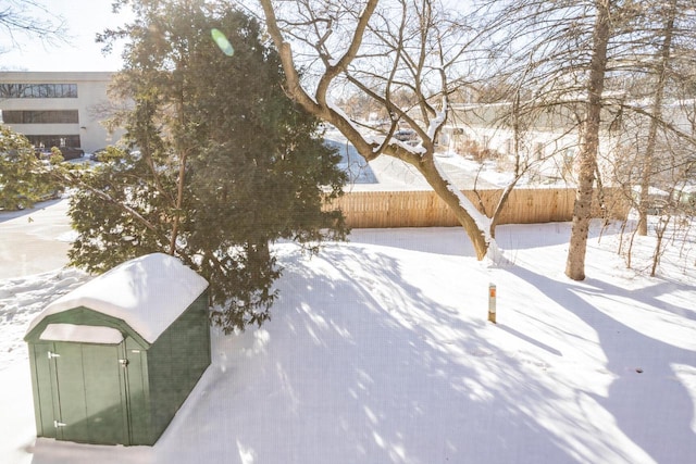 yard covered in snow with fence