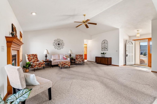 carpeted living area featuring a ceiling fan, vaulted ceiling, a fireplace, and baseboards