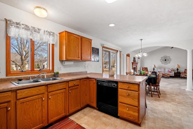 kitchen featuring a sink, black dishwasher, arched walkways, a peninsula, and ornate columns