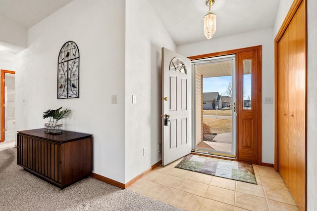 entryway with light tile patterned floors and baseboards