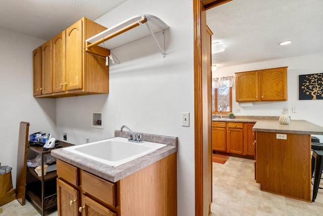 washroom featuring hookup for an electric dryer, recessed lighting, cabinet space, a sink, and washer hookup